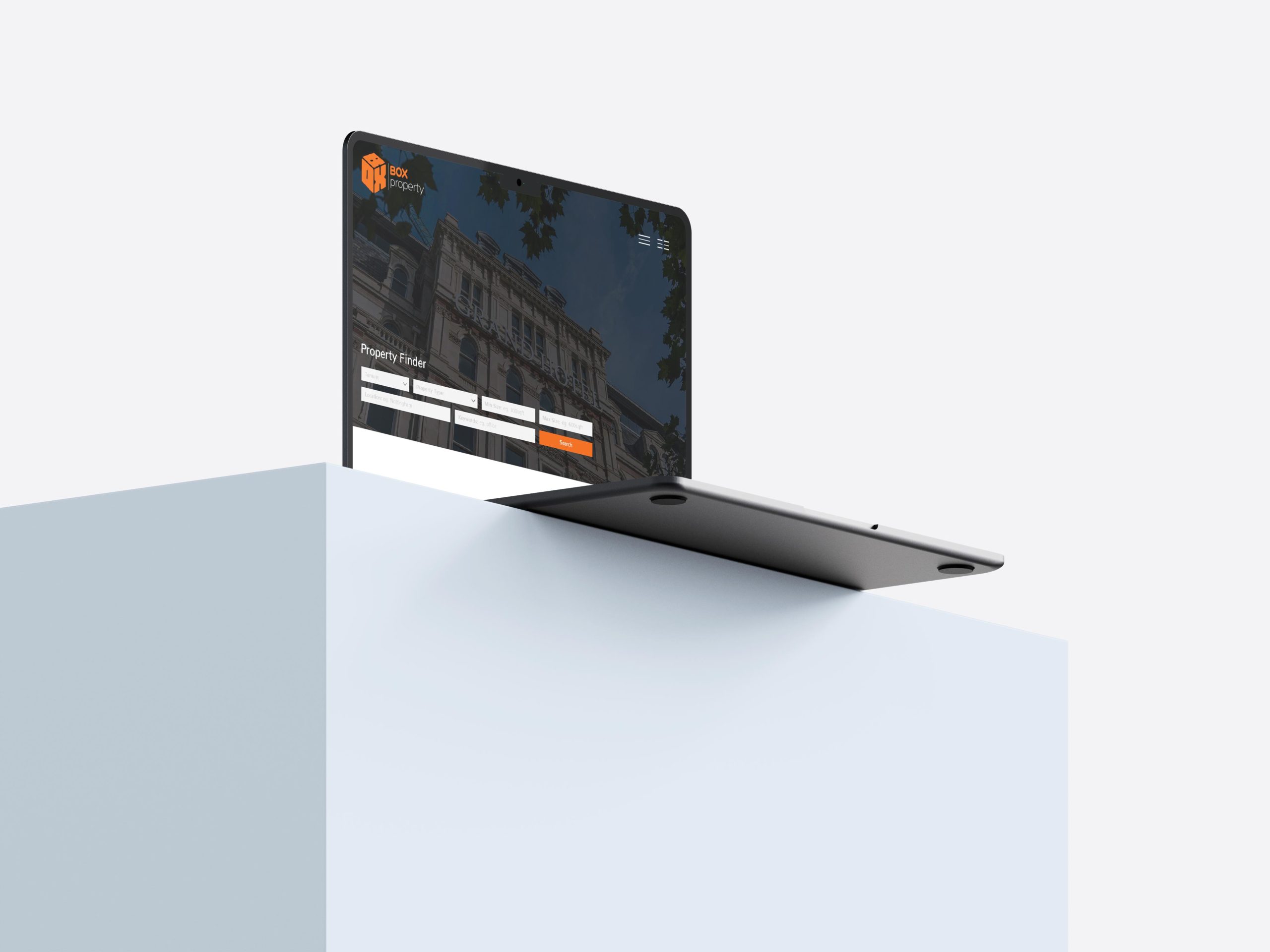 A laptop showcasing the Box Property website design which included a property finder feature