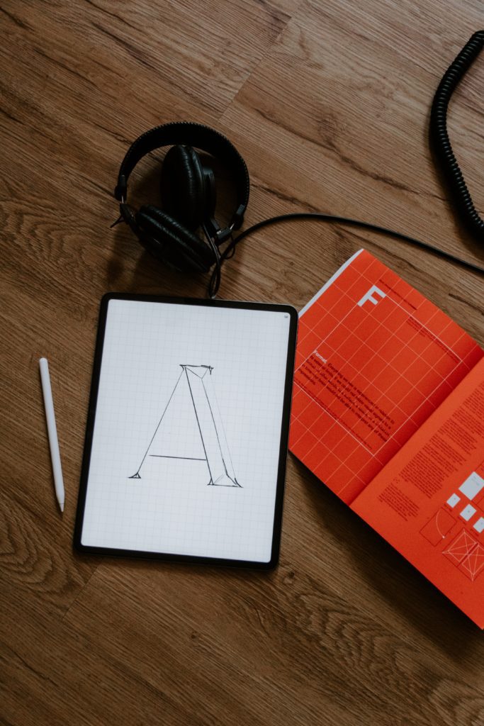 A tablet and book focusing on bespoke typography
